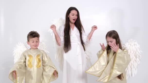 Mom with son and daughter, they have angel wings on a white background - Footage, Video