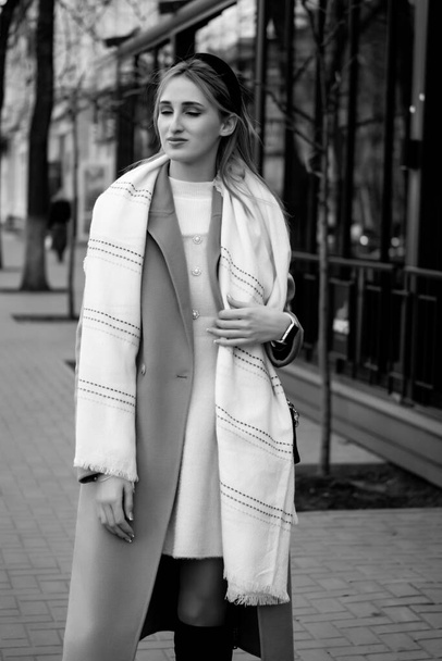 beautiful caucasian girl in a fur coat and hat walks around the city. Business concept. Business lady - Fotografie, Obrázek