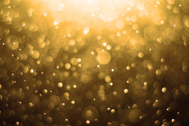 Golden background. Abstract gold background. Festive Golden Christmas Background.Background is glittering with golden light,bokeh defocused light. - Photo, Image