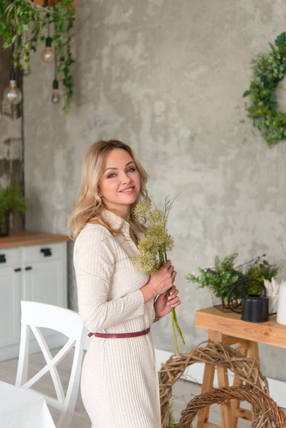 Beautiful happy woman with flowers indoors  - Foto, Bild