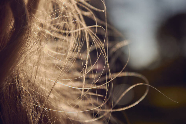 Girl's hair close up. Long shabby women's hair. Black and white photo.  - Fotoğraf, Görsel