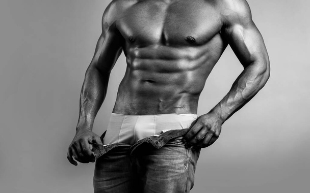 Man with sexy body. Guy undress his pants. - Foto, Imagem