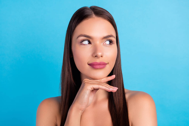 Portrait of positive curious girl look empty space make double chin removal surgery isolated on blue color background - Foto, afbeelding