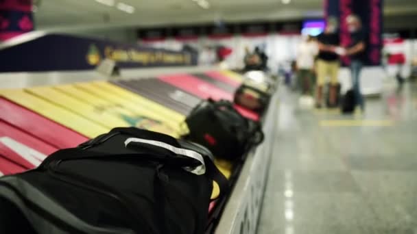 Baggage claim conveyor belt at arrival area in the international airport, pick up luggage, passenger terminal, baggage claim belt, travel insurance, lost and found belongings, public transportation - Filmati, video