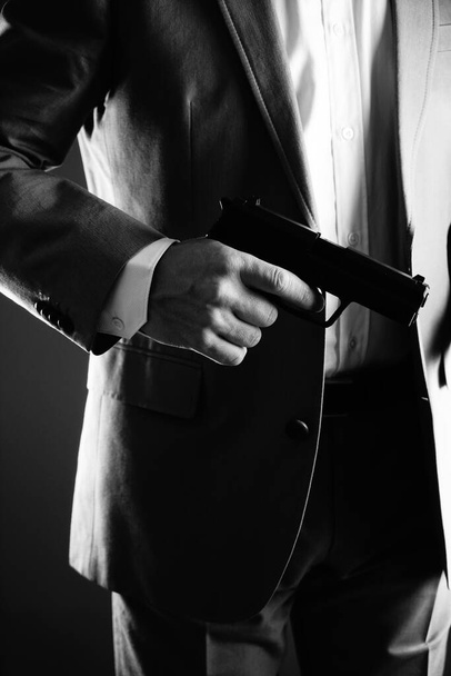 Retro secret agent with pistol revolver gun in hand in vintage crime thriller mockup cover     photo.        - 写真・画像