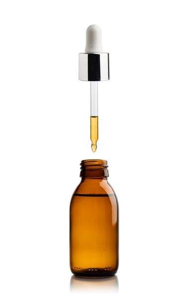 Cosmetic bottle of essential oil with pipette dripping oil - Photo, Image