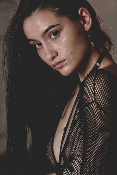 Close-up portrait of a young brunette woman in black lingerie - Fotoğraf, Görsel
