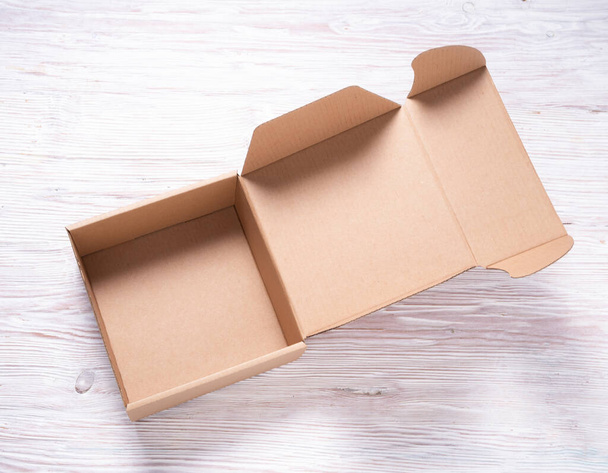 Brown Corrugated Cardboard Mailer Box on wooden desk - Fotografie, Obrázek