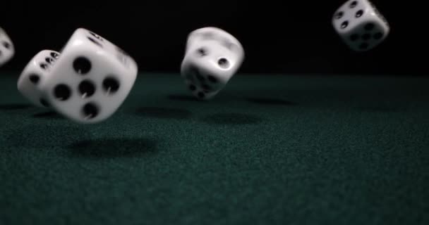 Rolling dice in slow motion. Dices falling to green table. Gambling and casino concept - Footage, Video