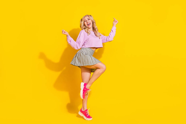 Full body photo of cheerful gorgeous lady enjoy clubbing discotheque free time isolated on yellow color background - Foto, afbeelding