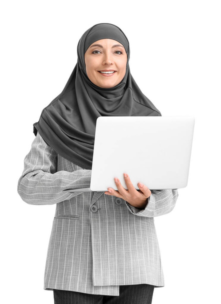 Muslim secretary with laptop on light background - Foto, imagen