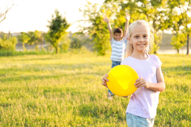 Cute little children playing frisbee outdoors - Photo, Image