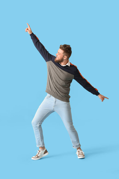Cool dancing young man on color background - Photo, Image