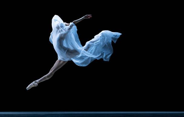 Graceful classic ballerina dancing with weightless fabric isolated on black studio background in neon. - Foto, Imagen