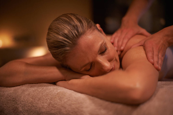 Massaging the stress away. Cropped shot of a woman in a day spa getting a massage. - 写真・画像