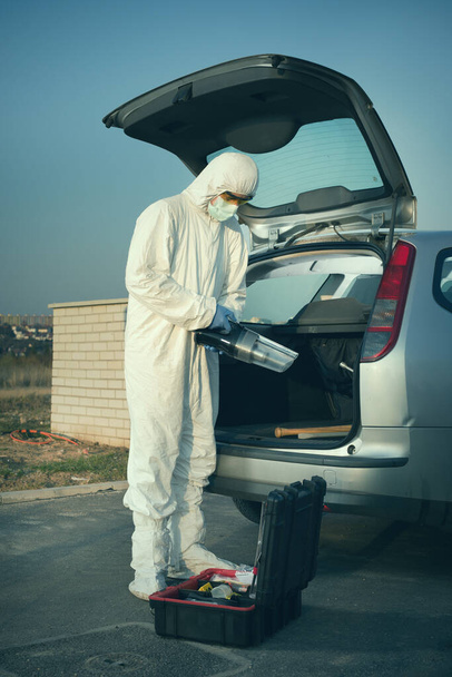 Criminologist technician collecting evidence with vacuum and micro filter - Fotoğraf, Görsel