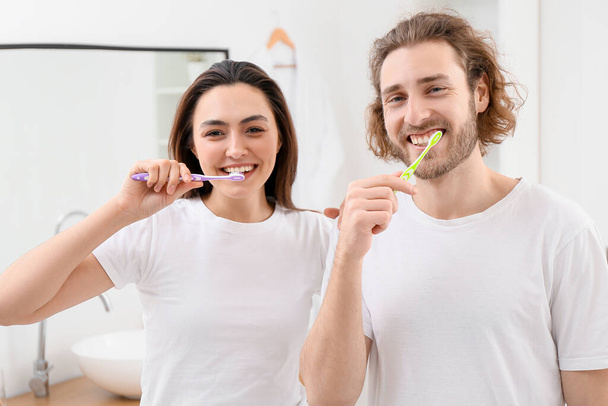 Lovely couple brushing teeth in bathroom - Photo, Image
