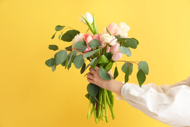 Female hands with bouquet on color background - Photo, Image