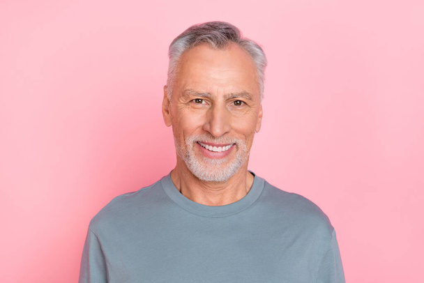 Photo of cheerful funny funky retired man wear grey shirt smiling isolated pink color background - 写真・画像