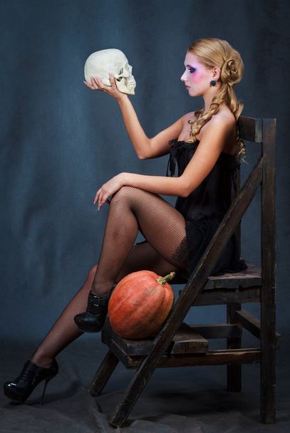 Blonde woman with skull and pumpkin - Photo, Image