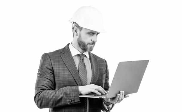 businessman man in suit and safety helmet wotking on laptop online isolated on white, work online. - Photo, Image
