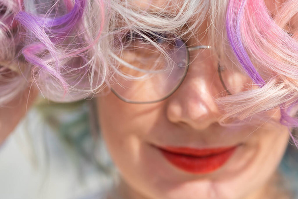 Close-up portrait of curly Caucasian woman with multi-colored hair. Model for hairstyles - Photo, Image