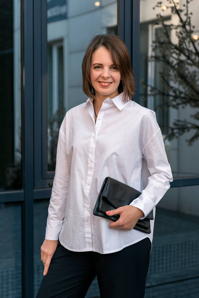 Stylish young woman in classic white shirt. Semi-casual style. Happy successful woman. - Photo, Image