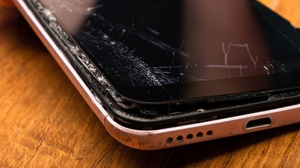 broken glass of mobile phone close-up detail cracked gadget screen. - Foto, immagini