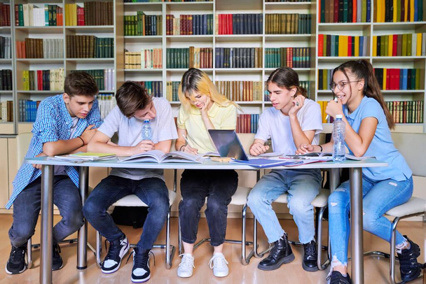 Group of teenage students study in library class. - Φωτογραφία, εικόνα