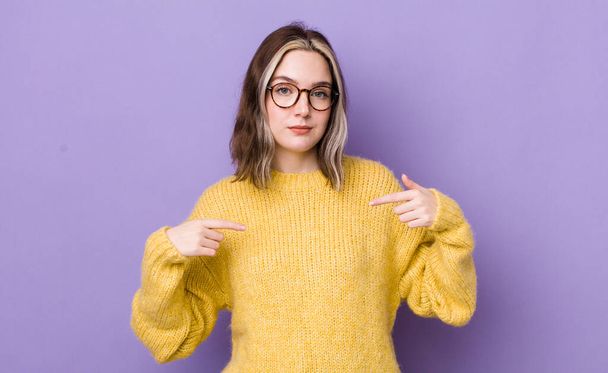 pretty caucasian woman looking proud, positive and casual pointing to chest with both hands - Foto, immagini