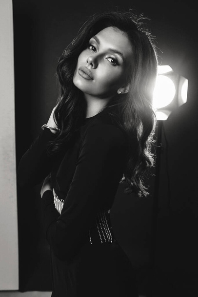 fashion photo of beautiful woman with dark hair in elegant outfit posing in studio - Foto, Imagem