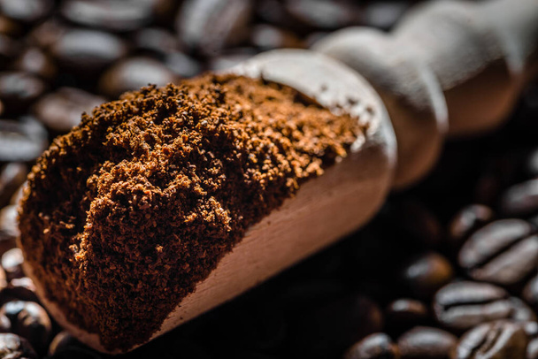 Aromatic powdered coffee beans in scoop. - Photo, image