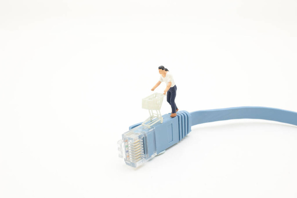 miniature people figurine trolly shopping cart, LAN local area network cable  - Foto, Bild