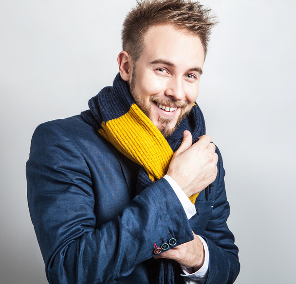 Elegant & Positive young handsome man in colorful scarf. Studio fashion portrait. - Foto, Imagen