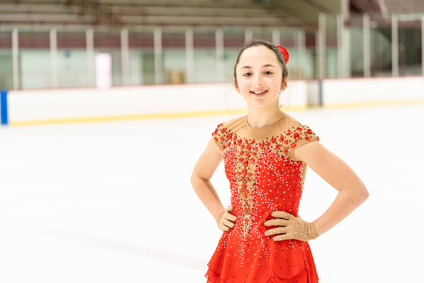 Teenage girl practicing figure skating on an indoor ice skating rink. - Photo, Image