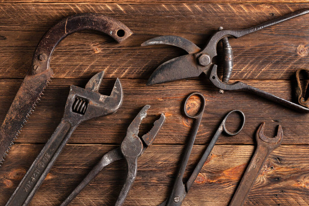 Dirty set of hand tools on a wooden boards. - Fotoğraf, Görsel