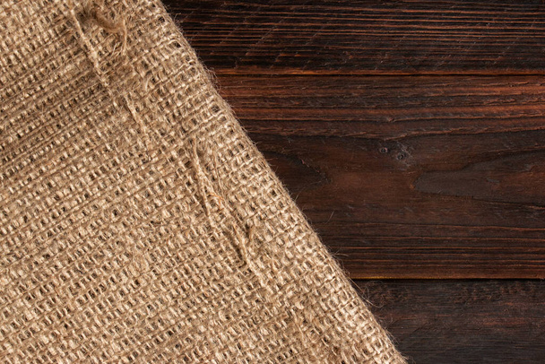 Wood table with old burlap tablecloth texture. - Valokuva, kuva