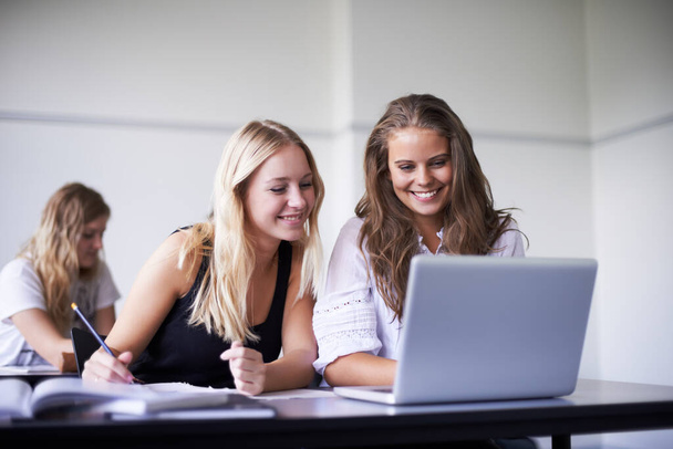 Každý den se učí nové věci. Dvě nádherné dospívající dívky pracující na notebooku ve třídě. - Fotografie, Obrázek