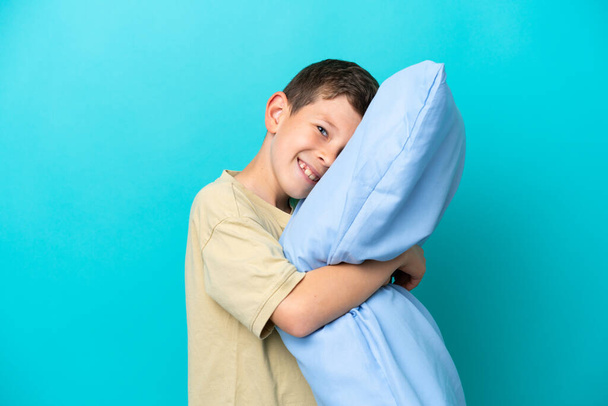 Little boy in pajamas isolated on blue background - Photo, Image