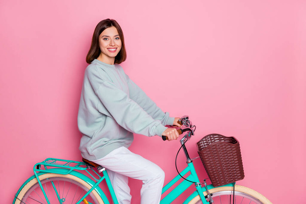 Profile side photo of youth lovely lady enjoy ride bicycle free-time isolated over pink color background - Φωτογραφία, εικόνα