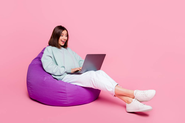 Full length profile side photo of young excited girl speak laptop conference isolated over pink color background - Φωτογραφία, εικόνα