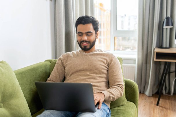 Indian stylish man talking by video call, discussing work process, employer lead job interview with applicant laptop screen, businessman talk with client - Foto, imagen