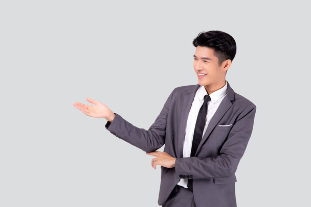 Portrait young asian business man in suit presenting isolated on white background, advertising and marketing, executive and manager, male confident showing success, expression and emotion. - Photo, Image