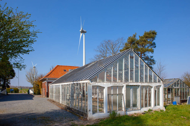 Near the windmills there is an old large greenhouse - Photo, Image