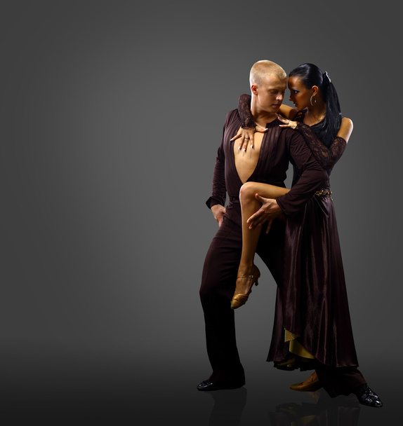 Dancers against black background - Foto, Imagen