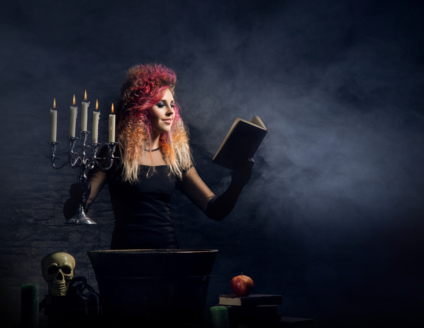 Beautiful witch making witchcraft - 写真・画像