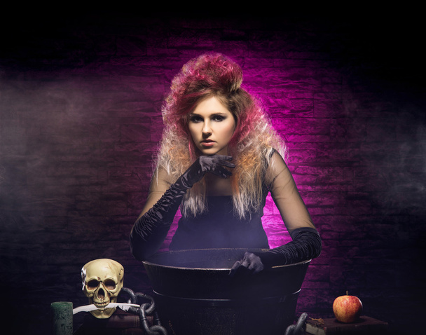 Young and beautiful witch in dungeon - Photo, Image