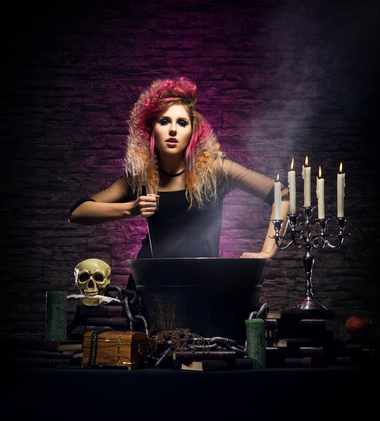 Young and beautiful witch in dungeon - Foto, imagen