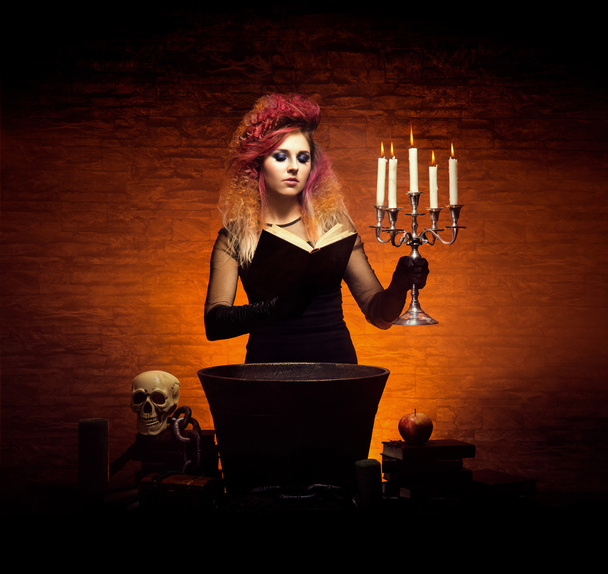 Young and beautiful witch making witchcraft - Foto, Imagen
