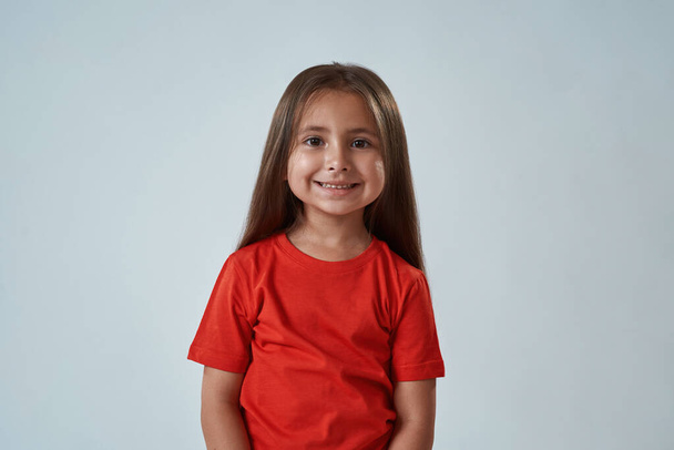Cropped image of cute little girl look at camera - Foto, imagen